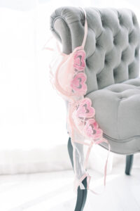 A bra by the brand Hello LA girl hangs on a bench at the boudoir studio in Huntington Beach that OC Boudoir shoots at.