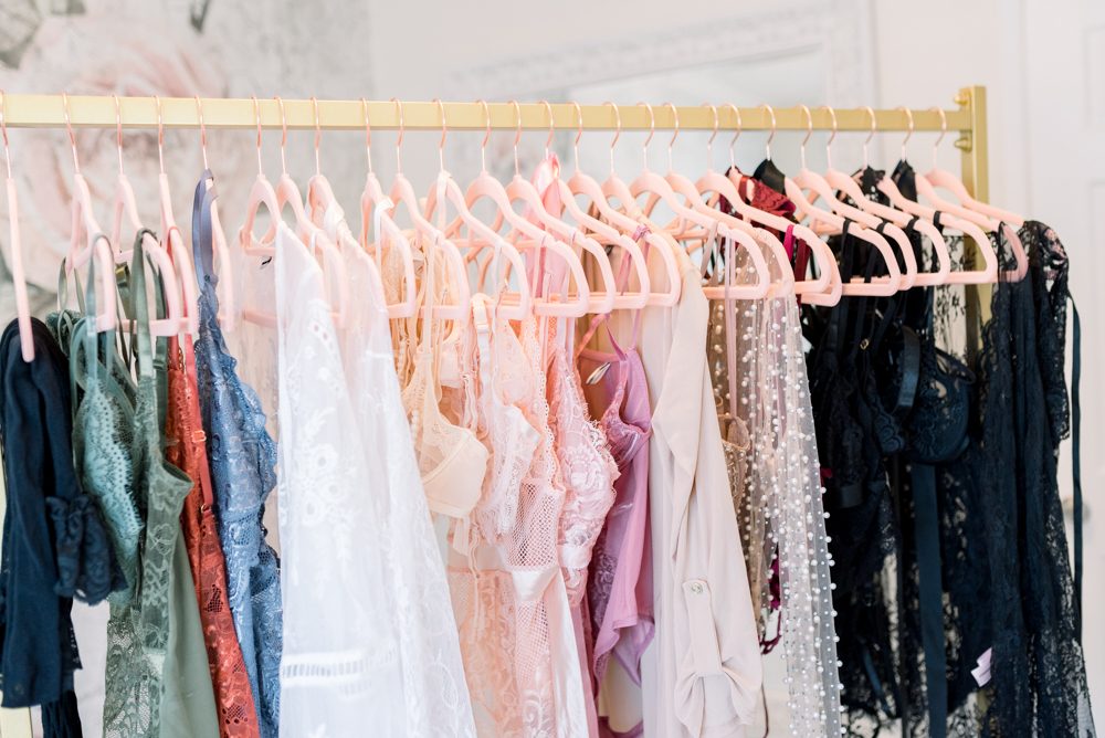 what to wear to a boudoir session, lingerie hanging on a rack with shoes ready for a boudoir photoshoot in Huntington Beach, California with OC Boudoir