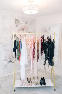 what to wear to a boudoir session, lingerie hanging on a rack with shoes ready for a boudoir photoshoot in Huntington Beach, California with OC Boudoir