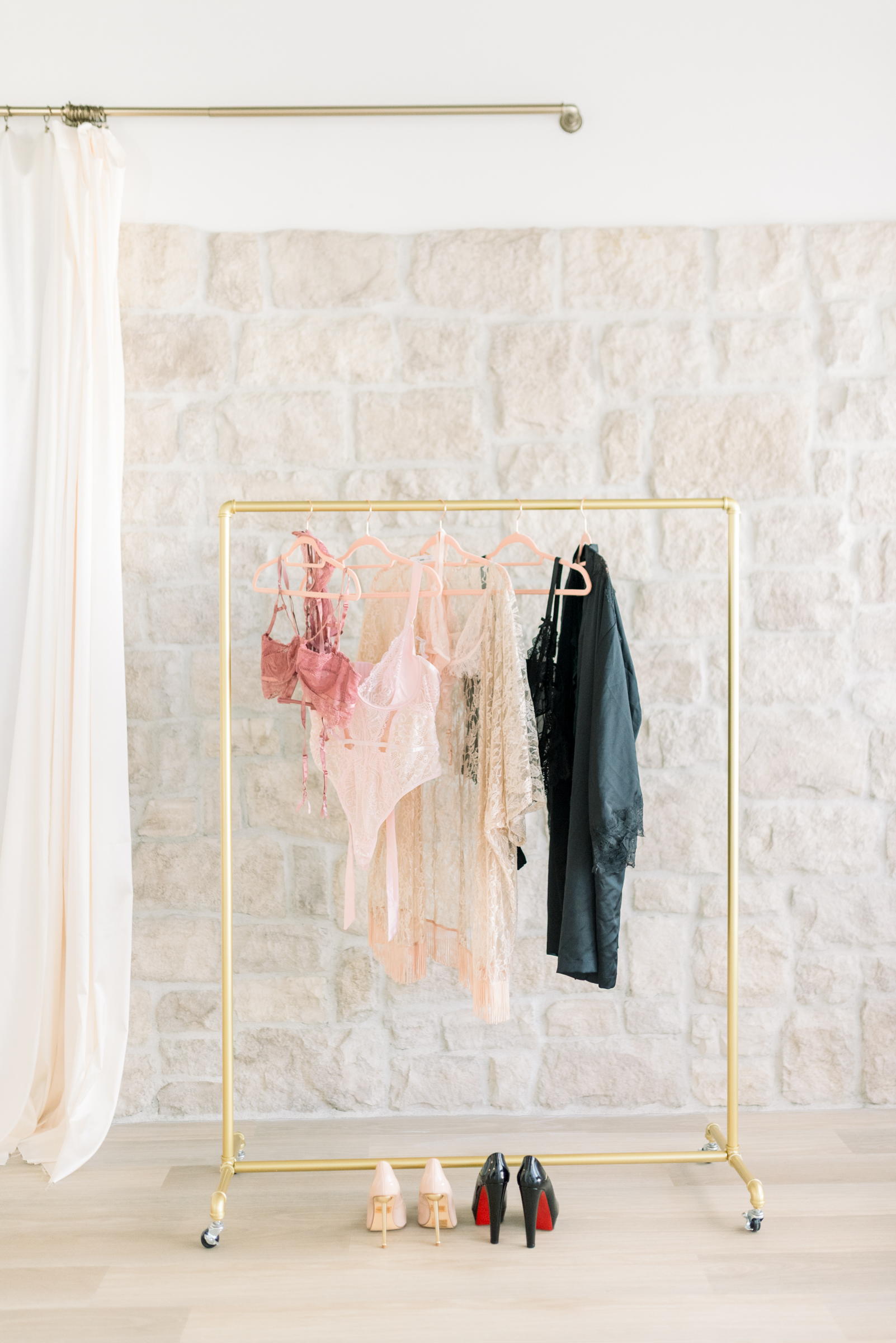 A curated outfits arranged in a wardrobe, helping clients choose the best color for boudoir photos