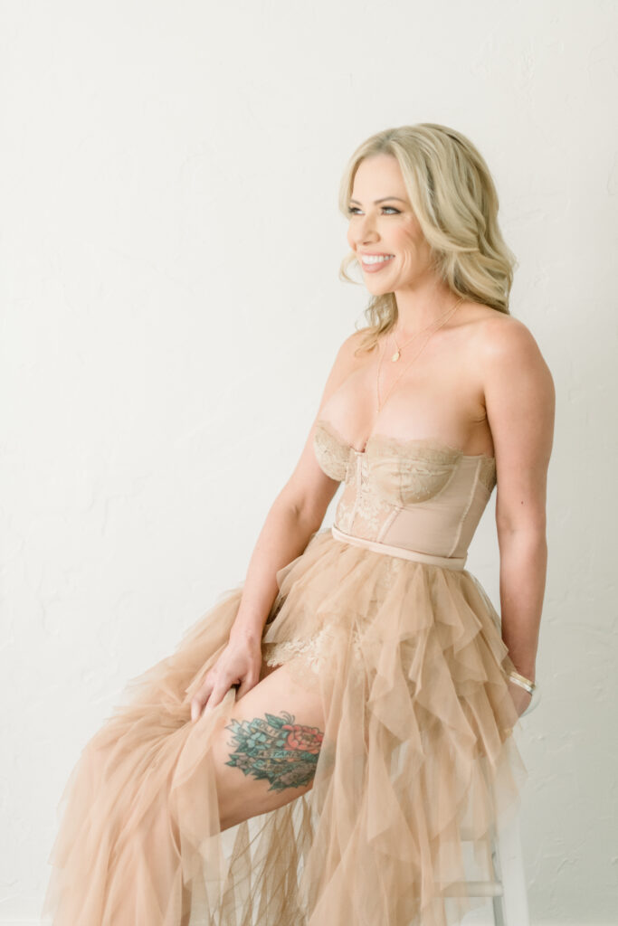 Woman wearing a nude dress during a boudoir photography session, showcasing one of the best color for boudoir photos