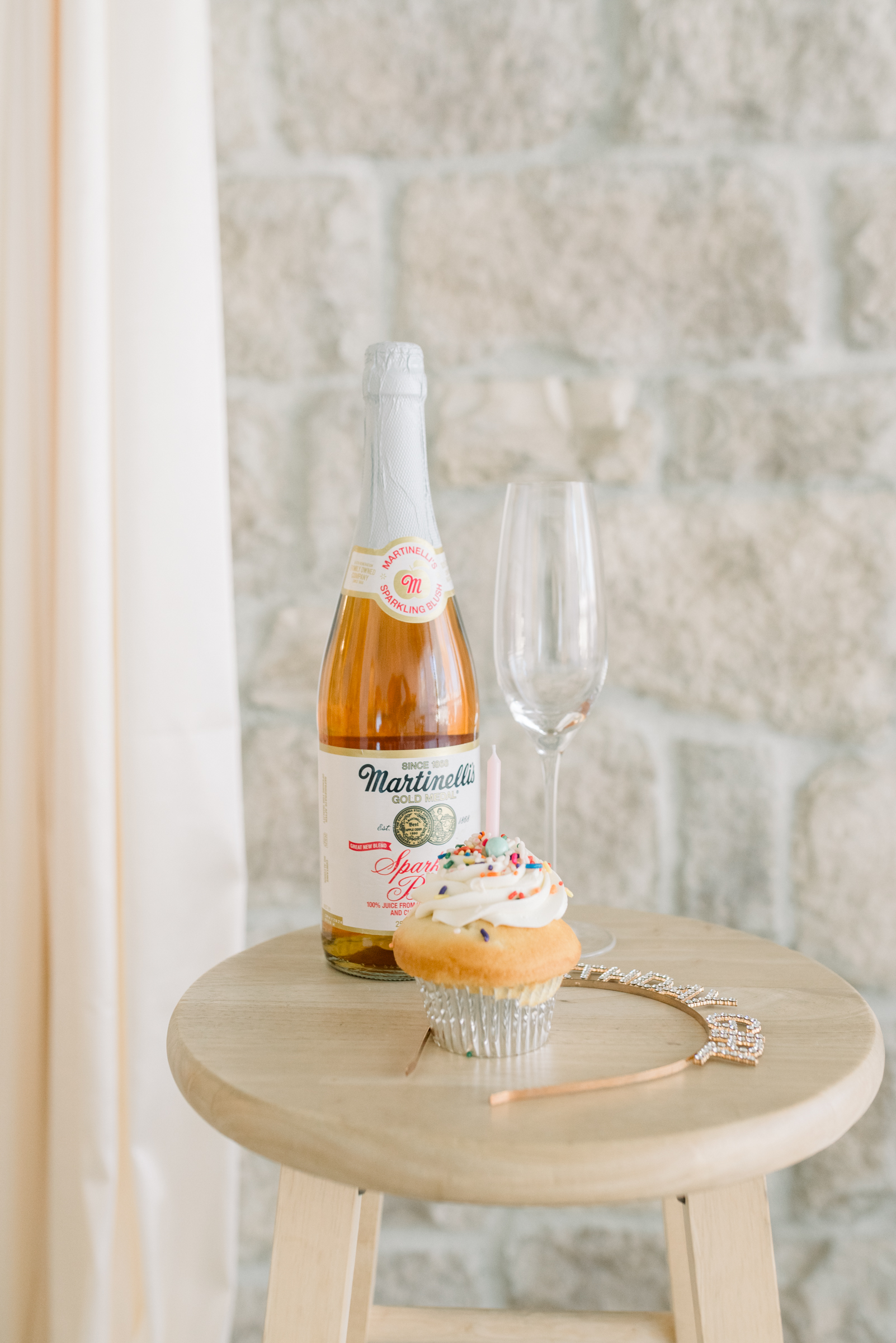 Birthday boudoir session featuring a cupcake and glass of wine for a special celebration.