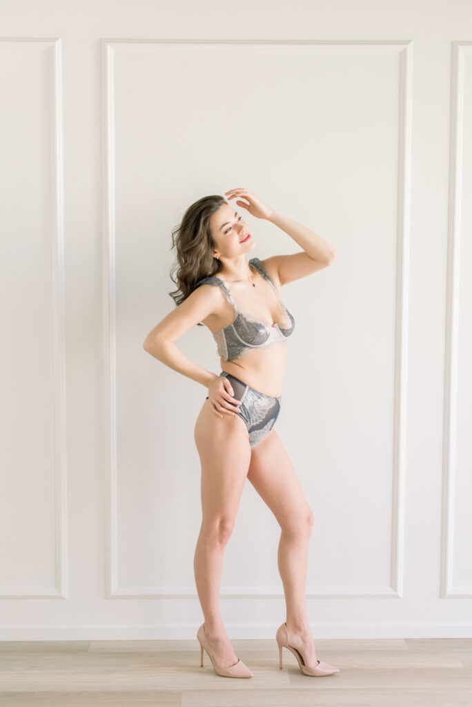 Woman confidently wearing lingerie during a boudoir photography session